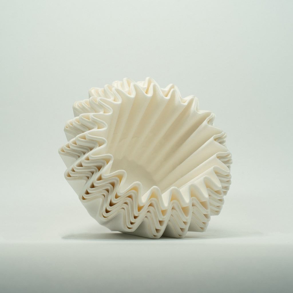 A stack of OSMO Wave filters outside of the packaging, at an angle, on a white background