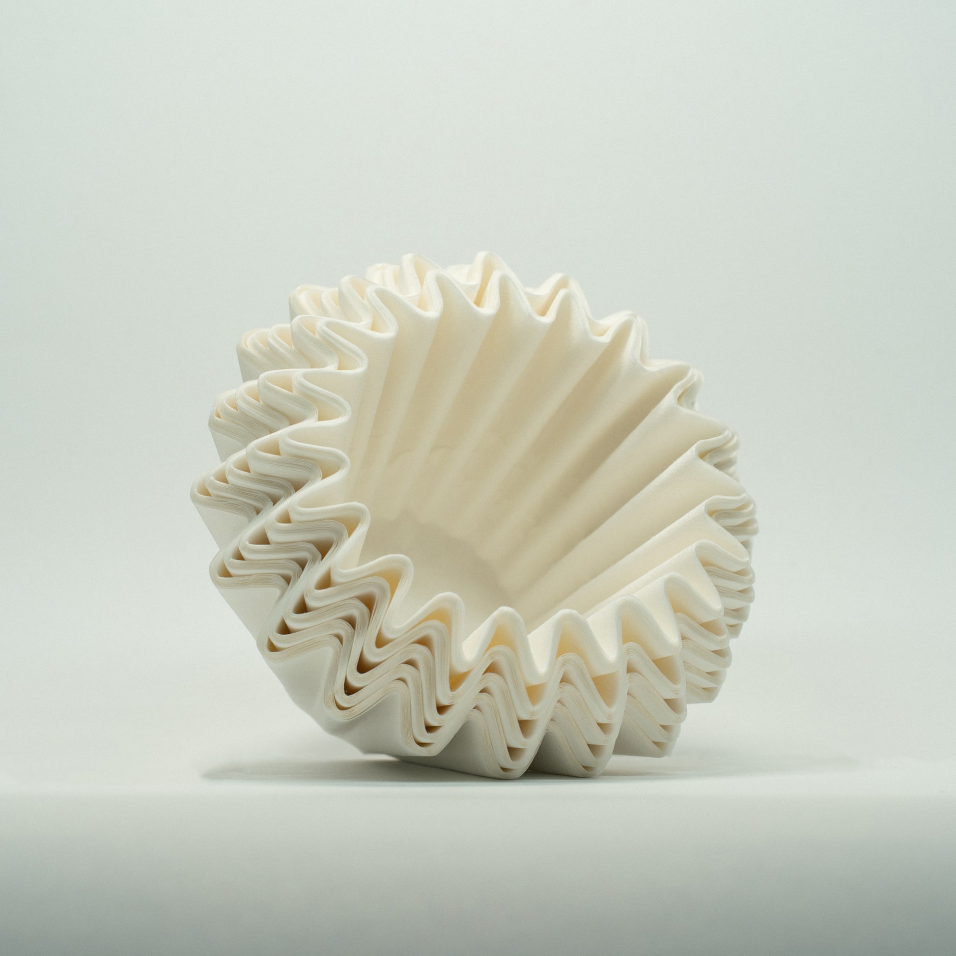 A stack of OSMO Wave filters outside of the packaging, at an angle, on a white background
